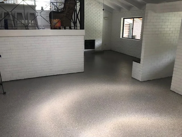 Downstairs living area after epoxy coating by Tough Floors